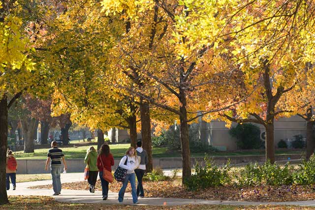 Students walking through the UNT campus in the fall.