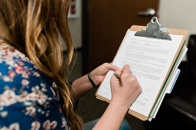 A counseling student fills out a form