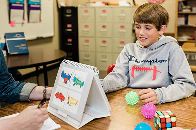 A teacher working with a student