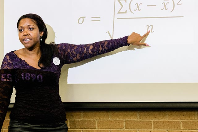  A UNT students presents information about the research, measurement and statistics program