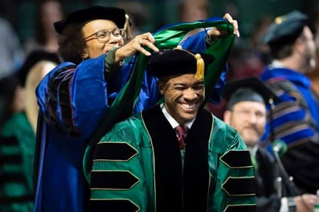 A UNT student receives his Ph.D. award