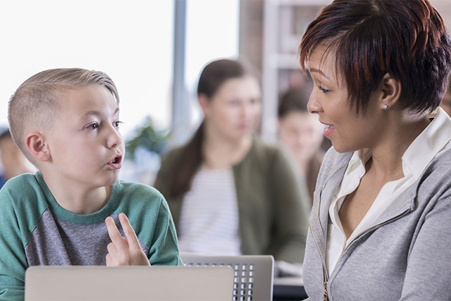 Principal working with a student