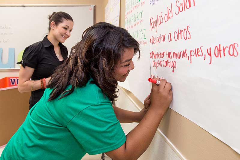 Student writing on the board