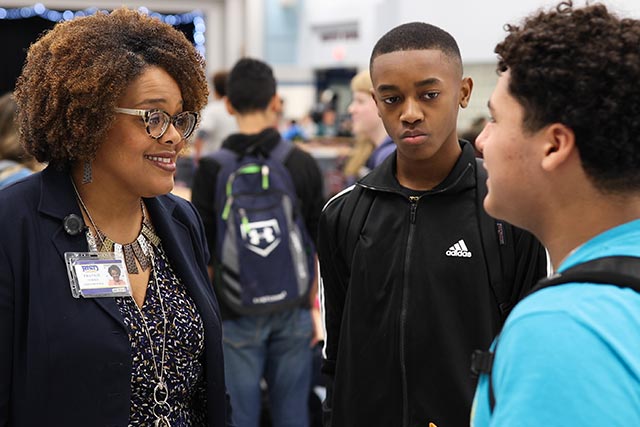 Instructor speaking with students