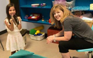 Dee Ray with a young girl in a play room at the Center for Play Therapy